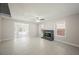 Bright living room featuring a brick fireplace, tile floors, and large windows for ample natural light at 111 Pomelo Ct, Henderson, NV 89074