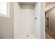 Shower with subway tile surround, a modern shower head, and a glass door at 111 Pomelo Ct, Henderson, NV 89074