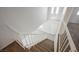 View down the carpeted stairs toward the bright entry featuring tile flooring at 111 Pomelo Ct, Henderson, NV 89074