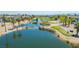 Panoramic aerial view showcasing the community's lush landscaping, serene lake, and the golf course at 11359 Winter Cottage Pl, Las Vegas, NV 89135