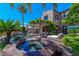 Resort-style backyard features a pool, spa, pergola with seating, and outdoor kitchen area for entertaining at 11359 Winter Cottage Pl, Las Vegas, NV 89135