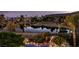 Stunning lake view from this property, complete with lush greenery, palm trees and mountain views at 11359 Winter Cottage Pl, Las Vegas, NV 89135