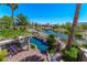 Aerial view of pool and water area of backyard, landscaped with mature trees at 11359 Winter Cottage Pl, Las Vegas, NV 89135