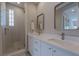 Bright bathroom featuring double sinks, a glass-enclosed shower, and modern fixtures for a spa-like experience at 11359 Winter Cottage Pl, Las Vegas, NV 89135