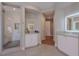 Spa-like bathroom with glass shower, sleek white cabinetry, and stylish lighting for a luxurious experience at 11359 Winter Cottage Pl, Las Vegas, NV 89135