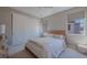 Comfortable bedroom with plush carpet, a cozy bed, and ample natural light from the large windows at 11359 Winter Cottage Pl, Las Vegas, NV 89135