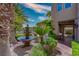 Charming courtyard with fountain, lush greenery, and manicured landscaping at 11359 Winter Cottage Pl, Las Vegas, NV 89135