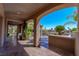 Spacious covered patio with outdoor kitchen overlooking pool and water feature at 11359 Winter Cottage Pl, Las Vegas, NV 89135