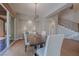 Dining room featuring a rustic wood table, modern lighting, and access to the outdoor patio at 11359 Winter Cottage Pl, Las Vegas, NV 89135