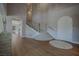 Grand foyer with a curved staircase, hardwood floors, and an elegant design at 11359 Winter Cottage Pl, Las Vegas, NV 89135