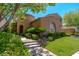 Well-maintained front exterior featuring lush landscaping and a charming facade at 11359 Winter Cottage Pl, Las Vegas, NV 89135