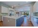 Modern kitchen with a large island, stainless steel appliances, and an open floor plan leading to the living area at 11359 Winter Cottage Pl, Las Vegas, NV 89135