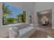 Living room offering views of lush landscaping and an outdoor patio space at 11359 Winter Cottage Pl, Las Vegas, NV 89135