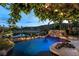 Stunning pool with rock waterfall feature and lush greenery at 11359 Winter Cottage Pl, Las Vegas, NV 89135