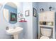 Cozy powder room with pedestal sink and decorative art at 11739 Village Arbor St, Las Vegas, NV 89183