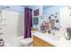 Bathroom featuring blue walls, a shower and tub combination, and storage in the vanity at 11739 Village Arbor St, Las Vegas, NV 89183