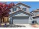 Inviting two-story home features a well-manicured front yard and a convenient two-car garage at 11739 Village Arbor St, Las Vegas, NV 89183