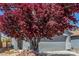 Two-story home features a well-maintained front yard, complemented by a convenient two-car garage at 11739 Village Arbor St, Las Vegas, NV 89183