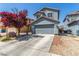 Charming two-story home with a gray exterior, a well-maintained yard, and a convenient two-car garage at 11739 Village Arbor St, Las Vegas, NV 89183