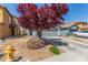 Two-story home features a well-maintained front yard and a convenient two-car garage at 11739 Village Arbor St, Las Vegas, NV 89183