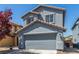 Two-story home features a well-maintained front yard and a two-car garage at 11739 Village Arbor St, Las Vegas, NV 89183