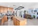 Open concept kitchen with tile flooring, center island, flowing into the adjacent living area at 11739 Village Arbor St, Las Vegas, NV 89183