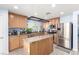 Well-lit kitchen featuring stainless steel appliances, tile countertops, and a central island at 11739 Village Arbor St, Las Vegas, NV 89183