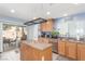 A kitchen with stainless steel appliances, tile countertops, and a view to a patio through sliding glass doors at 11739 Village Arbor St, Las Vegas, NV 89183