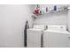 Functional laundry area with washer, dryer, and storage shelves at 11739 Village Arbor St, Las Vegas, NV 89183