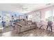 Spacious living room with wood floors, light pink and blue walls, and natural light from the windows at 11739 Village Arbor St, Las Vegas, NV 89183