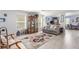 Bright living room featuring modern decor, wood-look floors, and a comfortable gray sofa at 11739 Village Arbor St, Las Vegas, NV 89183
