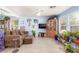 Inviting living room with wood-look floors, stylish furniture, decor, plants, and a large window at 11739 Village Arbor St, Las Vegas, NV 89183