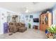 Comfortable living room with wood-look floors, large display cabinet, and view to open floorplan at 11739 Village Arbor St, Las Vegas, NV 89183