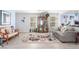 Bright living room featuring tile floors, a ceiling fan, and an open floor plan for seamless entertaining at 11739 Village Arbor St, Las Vegas, NV 89183
