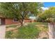 Backyard featuring trees, a well-maintained lawn, and privacy shrubs at 120 N Phyllis St, Las Vegas, NV 89110