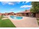 Expansive backyard with a pool, lush turf, and a built-in bar area, perfect for entertaining at 120 N Phyllis St, Las Vegas, NV 89110