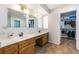 Bathroom with double sinks, wooden cabinets, a walk-in closet, and a view into the water closet at 120 N Phyllis St, Las Vegas, NV 89110