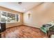 Bright bonus room with hardwood floors, a large window, and a comfortable chair to create a relaxing and inviting atmosphere at 120 N Phyllis St, Las Vegas, NV 89110