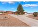 Beautiful home featuring a long driveway with desert landscaping and a charming fire pit at 120 N Phyllis St, Las Vegas, NV 89110