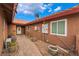 Charming home featuring a terracotta roof, a brick-paved walkway, and desert landscaping at 120 N Phyllis St, Las Vegas, NV 89110