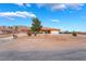Charming single-story home featuring desert landscaping, a spacious driveway, and mountain views at 120 N Phyllis St, Las Vegas, NV 89110