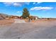 Well-maintained home featuring desert landscaping, a long driveway, and mountain views at 120 N Phyllis St, Las Vegas, NV 89110