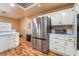 Bright kitchen features white cabinets, stainless steel appliances, and wood-look flooring at 120 N Phyllis St, Las Vegas, NV 89110