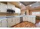 Well-lit kitchen features white cabinets, stainless steel appliances, and wood-look flooring at 120 N Phyllis St, Las Vegas, NV 89110