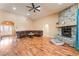 Inviting living room with wood floors, a stone fireplace, and a comfortable sectional sofa at 120 N Phyllis St, Las Vegas, NV 89110