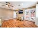 Large bedroom features hardwood floors, a ceiling fan, access to the backyard, and a view into the attached bathroom at 120 N Phyllis St, Las Vegas, NV 89110