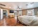 Main bedroom features wood floors, a ceiling fan, and a door leading to the backyard at 120 N Phyllis St, Las Vegas, NV 89110