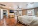 Spacious main bedroom with a fireplace, a ceiling fan, hardwood floors, and access to the backyard through french doors at 120 N Phyllis St, Las Vegas, NV 89110