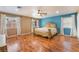 The main bedroom features wood floors, a ceiling fan, and large windows for lots of natural light at 120 N Phyllis St, Las Vegas, NV 89110