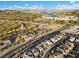 Picturesque aerial shot capturing a desert community with a lake, golf course, and scenic mountain backdrop at 14 Parco Fiore Ct, Henderson, NV 89011